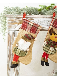 Detail of knitted Christmas stockings with 3D Santa and reindeer on white mantel