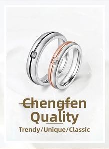 Close-up of minimalist couple rings with black and rose gold lines and set diamonds