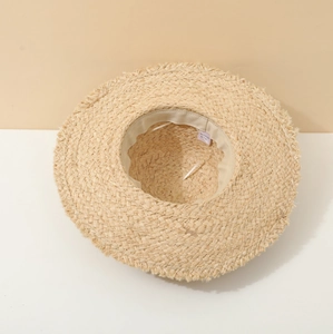 Detail of straw sun hat interior with sweatband and raw fringe edge for beach trips