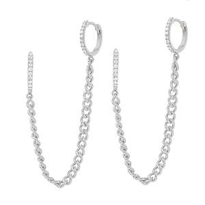 Detail of silver chain earrings with cubic zirconia studs and hanging tassel link