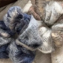 Macro shot of fluffy plush hair scrunchies in blue and grey showing soft texture