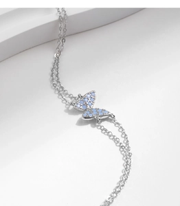 Detail of s925 silver double-layer bracelet featuring a blue crystal butterfly pendant