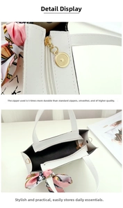 Detail of smooth gold zipper and spacious interior of the black and white handbag