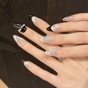 Handmade long almond press-on nails with black and glitter white ombre and 3D bows