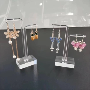 Detailed view of clear acrylic earring stands in four heights showing jewelry