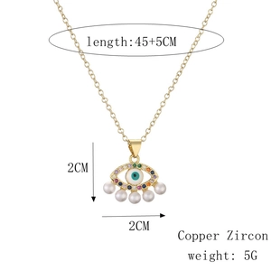 Detailed view of evil eye heart pendant with colorful zircon and small pearls