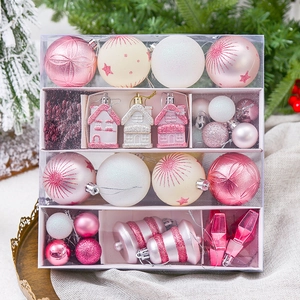 Pink and white Christmas ball ornament set in a clear gift box with various festive shapes