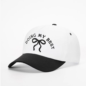 Detailed embroidery of DOING MY BEST text and bow design on two-tone baseball cap