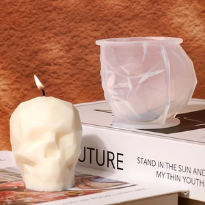 Detail of geometric skull silicone mold and a finished white faceted skull candle