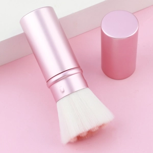 Close-up of cat paw retractable blush brush with soft fiber bristles and matte pink cap