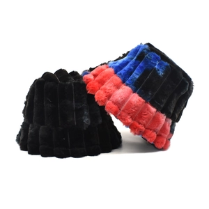 Plush faux fur winter bucket hats in solid black and colorful tie-dye rainbow patterns