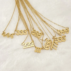 Fashionable gold stainless steel number necklaces 111-999 arranged on white fur