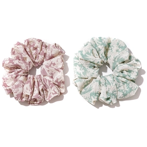 Oversized floral print scrunchies in pink and green fabric on a clean white background