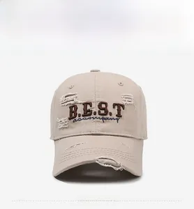 Detailed view of the embroidered 'B.E.S.T.' text and distressed fabric on the cotton cap