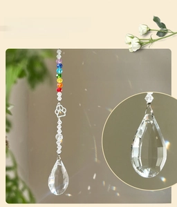 Macro detail of paw-shaped pendant and faceted crystal droplet for suncatcher