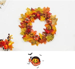 Close-up of fall wreath featuring vibrant maple leaves, mini pumpkins and berries