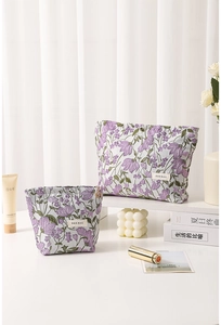 Close-up of a floral embroidered canvas makeup bag set with premium metal zipper detail