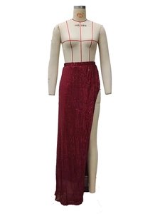 Dettaglio macro della gonna maxi di paillettes bordeaux con spacco alto e riflessi