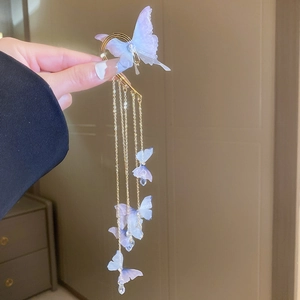 Vue détaillée d'un tour d'oreille papillon en tissu lavande avec de longues franges