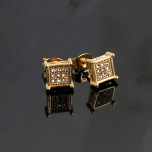 Detail of square gold stud earrings featuring a nine-grid cubic zirconia cluster setting