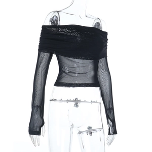 Detail of the sheer black mesh fabric and off-the-shoulder neckline on the long sleeve top