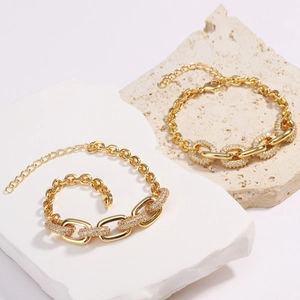 Hip hop 18K gold plated oval chain bracelet with micro-pave zircons on stone background