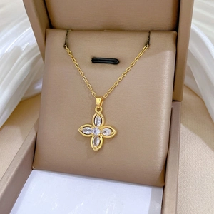 Close-up of gold clover necklace with marquise zircon petals in a jewelry box