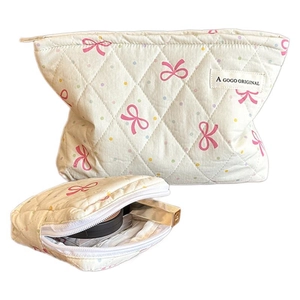 Quilted beige cosmetic bag set with pink bows and colorful polka dots pattern