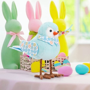 Detail of light blue Easter bird figurine with floral scarf and metallic wire legs
