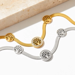 Golden and silver tree of life pendants on snake chains with sparkling zircon details