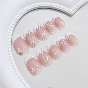 French press-on nails with silver bows and sparkling rhinestones on 3D metallic pink base