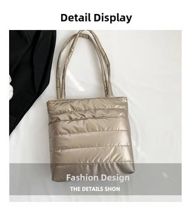 Close-up of metallic champagne gold quilted tote bag with padded handles and shiny texture