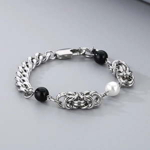 Macro detail of silver mixed chain bracelet with white and black pearl beads
