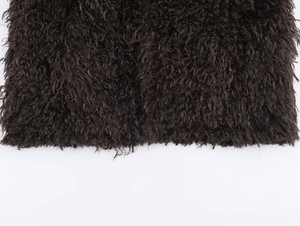 Detailed macro shot of thick dark brown faux fur texture on a fashion women jacket