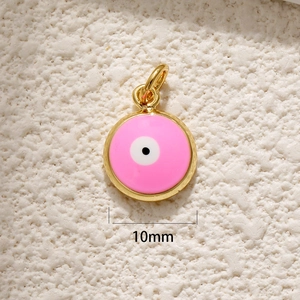 Close-up of pink round evil eye pendant in gold plating, 10mm diameter size detail