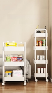 Detail view of white multi-tier slim rolling cart with wheels for kitchen storage