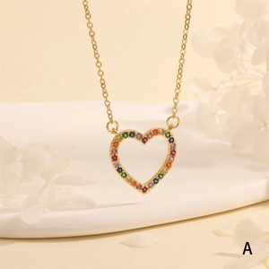 Detail view of heart-shaped gold necklace featuring multi-colored gemstones and cubic zirconia