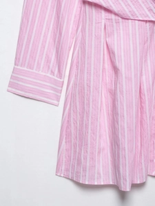 Close-up of pink and white striped V-neck dress showing cuff details and stitching