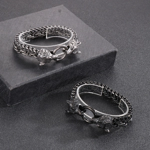 Detailed view of silver and black wolf head bracelets featuring double layered metal chains