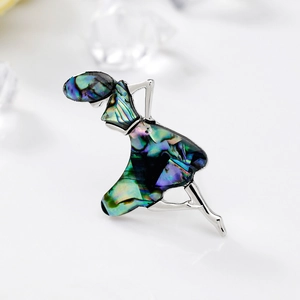 Elegant silver dancing girl brooch featuring iridescent abalone shell inlay on white backdrop