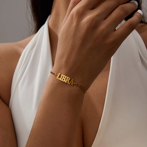 Golden Libra zodiac sign bracelet with polished letter pendant for women on wrist
