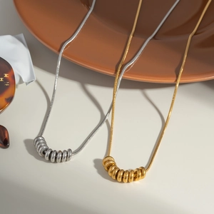 Minimalist stainless steel snake chain necklace with gold and silver bead pendants