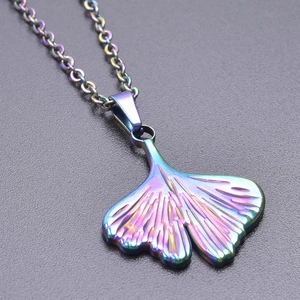 Macro shot of ginkgo leaf pendant with vibrant rainbow plating on a stainless steel chain