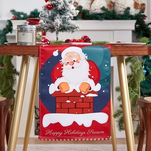 Christmas table runner with Santa Claus down the chimney design on red and blue linen