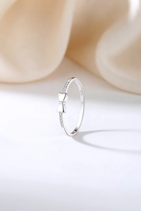 Detail of S925 sterling silver bow ring featuring micro-pave sparkling cubic zirconia