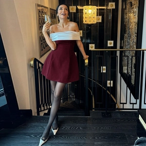 Detail of off-shoulder wine red and white mini dress with a slim fit waist design