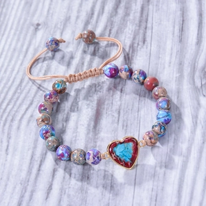 Bohemian 8mm natural stone beaded bracelet with heart pendant on rustic wood backdrop