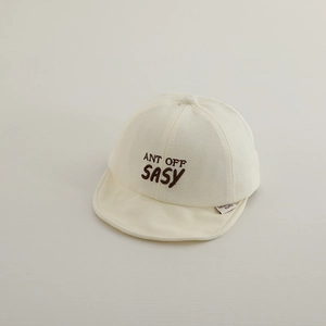Detailed close-up of embroidery text on a soft cotton baby baseball cap in beige