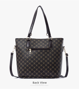 Detail view of large tote bag back featuring brown monogram print and zipper pocket