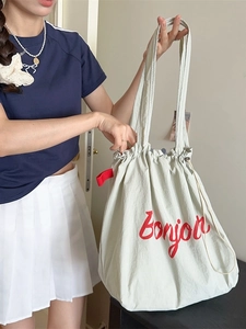 Minimalist drawstring tote bag in light grey with red bonjour print and shoulder straps